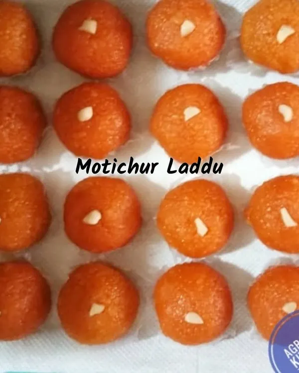 Perfectly round Motichur Laddus, made with tiny boondis soaked in sugar syrup and formed with pure ghee. Each laddu is garnished with a piece of nut, ready for your celebration.