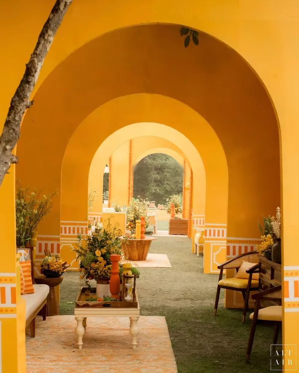 For the 'Kesar Sehar' Haldi, I wanted to celebrate the beauty of Indian heritage. I used a vibrant yellow and orange palette and created a corridor of arches, giving the space architectural depth and a feeling of walking through a modern Indian palace.