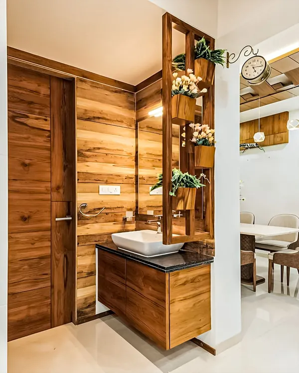A simple and elegant wash basin unit perfect for a dining area or powder room. The wood-paneled wall and vertical planter add a natural, organic touch.