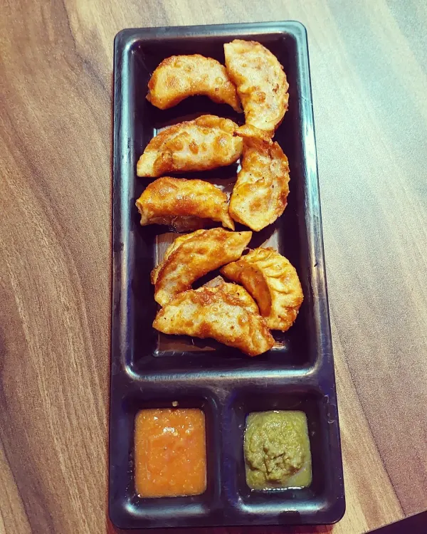 Our crunchy fried momos are a must-try. They are served with two chutneys, including our special Raja Marcha (King Chilli) chutney for that extra spicy kick.
