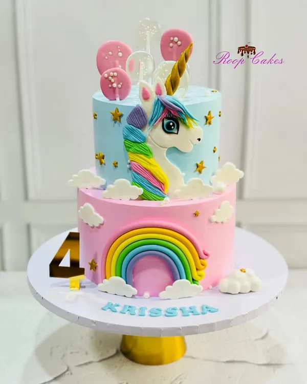 This two-tier unicorn cake was a dream to create for a magical 4th birthday. I handcrafted the fondant unicorn, rainbow, and clouds, and added shimmering stars and lollipops to complete this whimsical centerpiece.