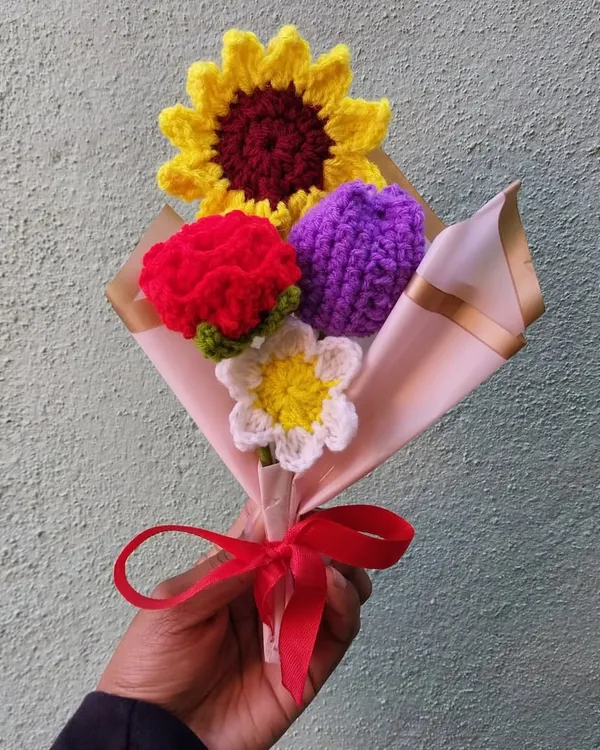 This is one of my favorite custom bouquets, featuring a bright sunflower, a red carnation, a purple tulip, and a delicate daisy. I love combining different flowers and colors to create something truly unique that will never wilt.