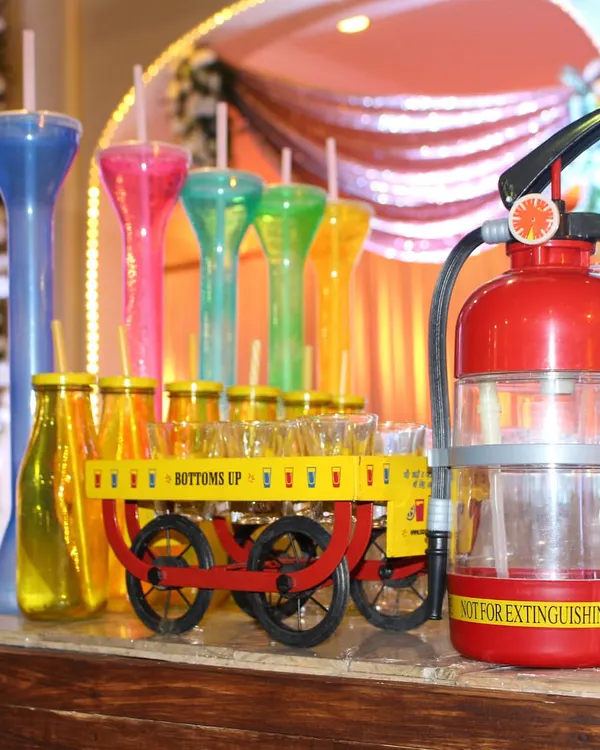 Why settle for ordinary sips? We bring the fun with unique serving methods like this shot cart, fire extinguisher dispenser, and colorful yard glasses.