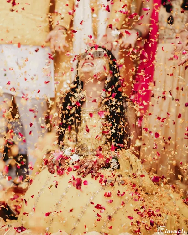 A moment of pure bliss as the bride is showered in flower petals during her Haldi ceremony. I use lighting to make the colors pop and capture the festive atmosphere.