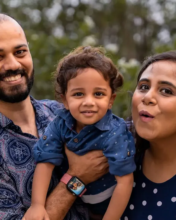 A happy family hug. This close up portrait shows a mother and father holding their smiling toddler, their expressions full of warmth and affection. It’s a perfect example of a relaxed family portrait that feels natural and full of love.