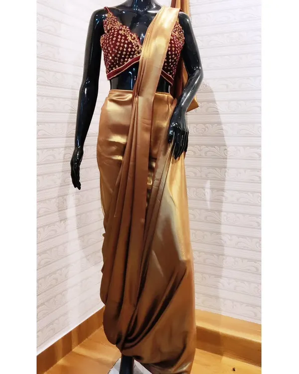 This is my take on the modern Indo-Western look. I designed this custom outfit featuring a pre-draped dhoti-style saree in lustrous gold satin, paired with a heavily embroidered maroon velvet blouse. It’s a perfect example of how I blend traditional concepts with contemporary fusion wear for a truly standout ensemble.