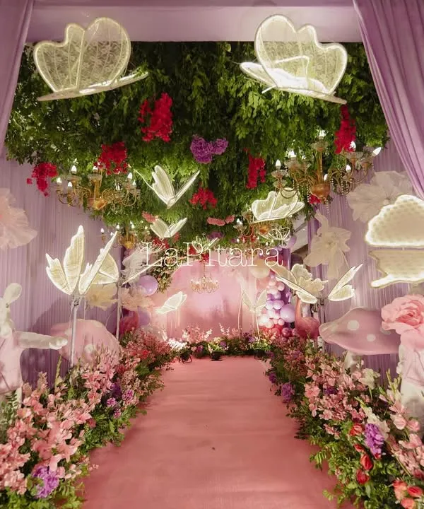 This enchanted garden entrance was designed to feel like stepping into a fairytale. We used glowing oversized butterflies, a lush floral pathway, and soft lavender draping to create a truly magical and immersive experience for guests from the very first moment.