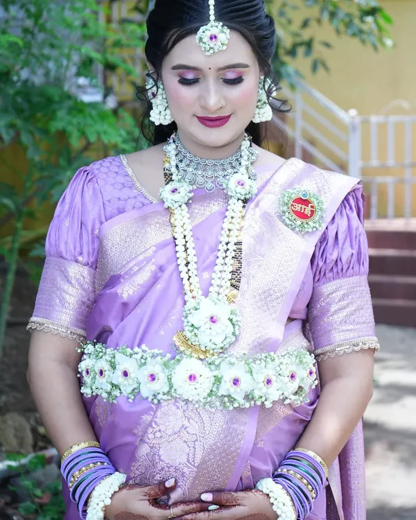 A beautiful mom-to-be wearing a full set of my white floral jewellery. This set includes a long necklace, a floral waist belt (kamarband), and matching armlets, all designed to complement her lavender saree.