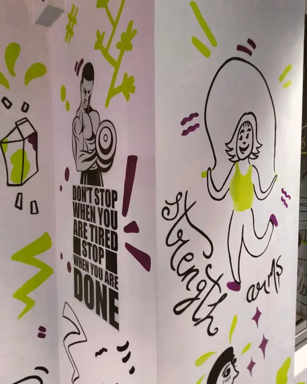 "Don't stop when you are tired, stop when you are done." This motivational doodle art for a gym in Bandra combines inspiring quotes with fun fitness-related illustrations like a skipping girl.