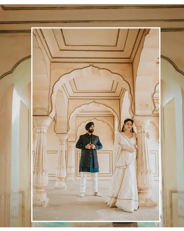 A majestic portrait set within the ornate corridors of a Jaipur palace, capturing a sense of royal grandeur and timeless love for this Sikh couple's pre-wedding shoot.