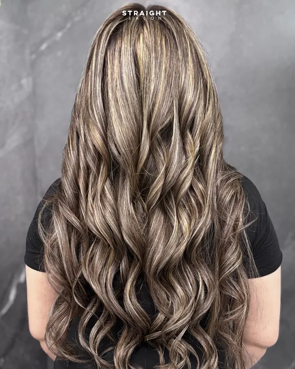When rich brunette meets soft blonde highlights, the result is this voluminous, high-contrast look that is pure hair envy.