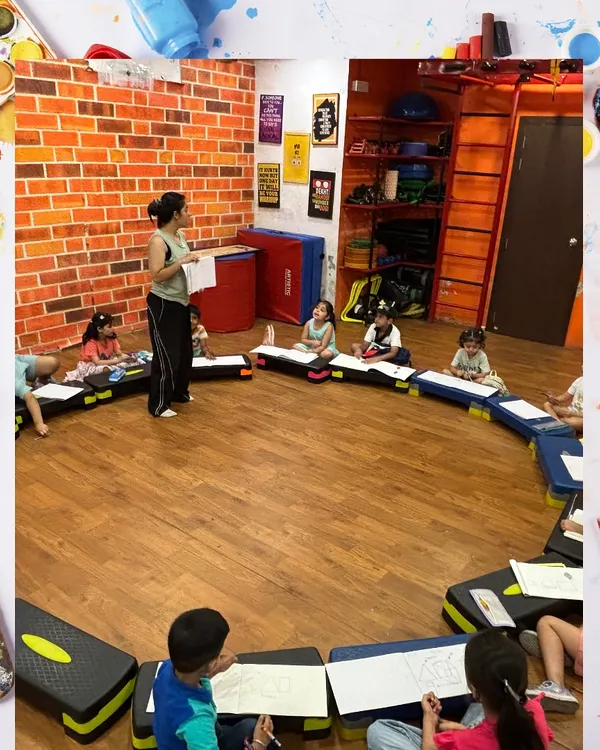 A wide shot of our art class in session. Students are seated in a circle, fostering a collaborative and interactive learning environment as they work on their drawings.