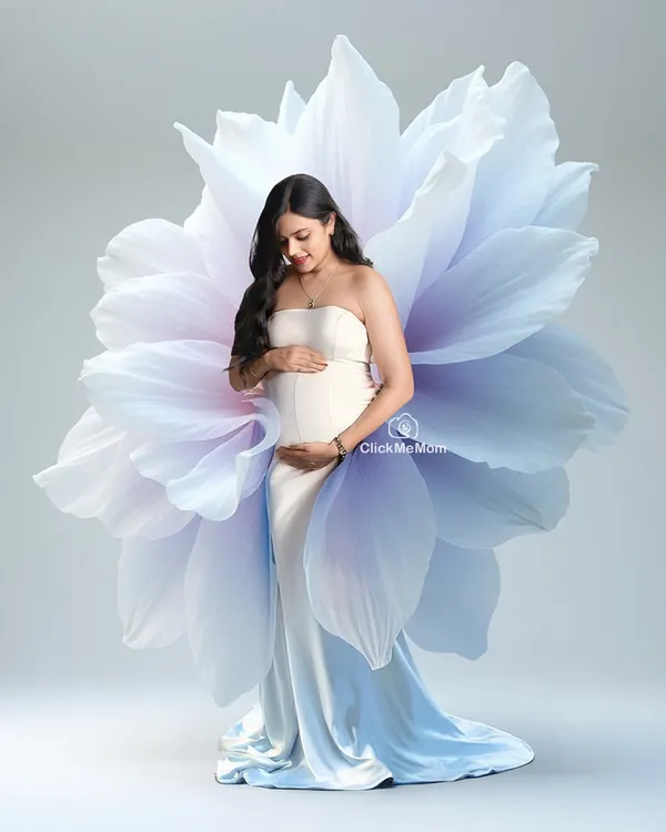 Blooming with life. In this artistic portrait, the mom-to-be emerges from a giant, ethereal flower, symbolizing the beauty and miracle of creation. It's a unique and conceptual maternity photo.