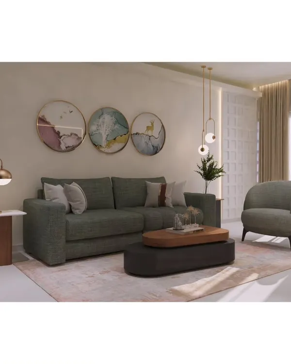 This living area showcases a blend of art and comfort. We paired a solid-colored sofa with a sculptural accent chair and a two-tiered coffee table, creating a balanced and welcoming space for relaxation.