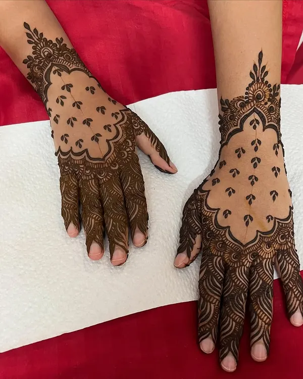 A stunning example of a "jaali" or net design, where the negative space is filled with delicate dots. I teach the technique for this intricate look.