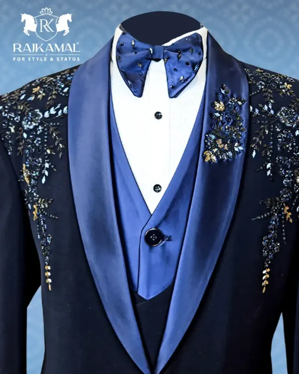 A detailed close-up of the hand-embroidery on a navy blue tuxedo. The combination of beads and threadwork on the satin lapel showcases my commitment to luxury craftsmanship.