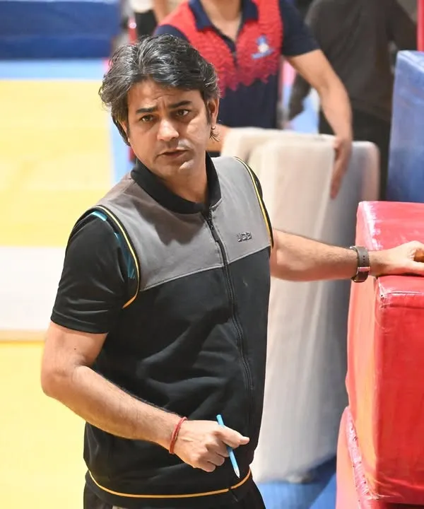 Head coach Praveen Sharma observing a training session. Every detail is monitored to ensure our gymnasts are developing correctly and safely.