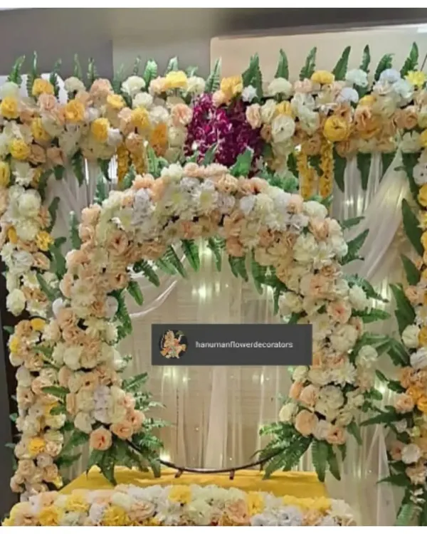 A lush and elegant floral frame I created for a Ganesh Chaturthi celebration. This design uses a mix of pastel yellow and peach roses with green foliage to create a soft and sophisticated backdrop for the idol.