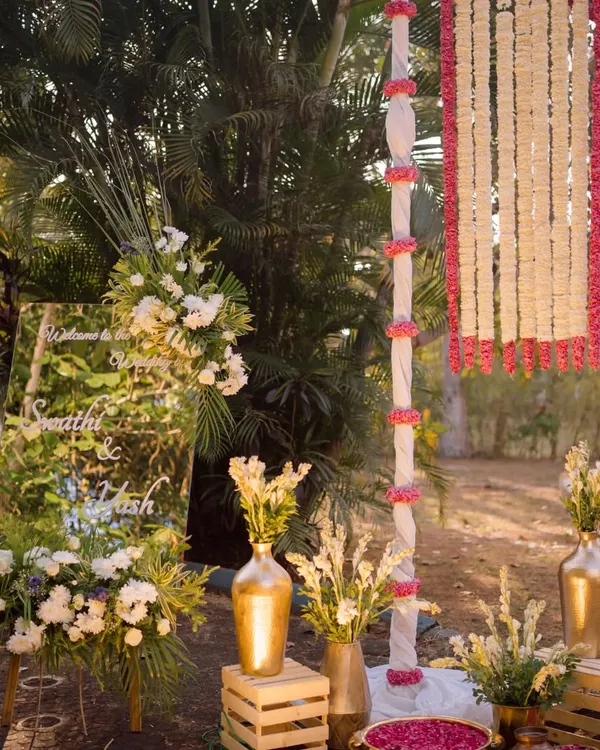 Our team setting up the entrance decor, ensuring the custom mirror sign and floral arrangements are perfectly placed to welcome guests.