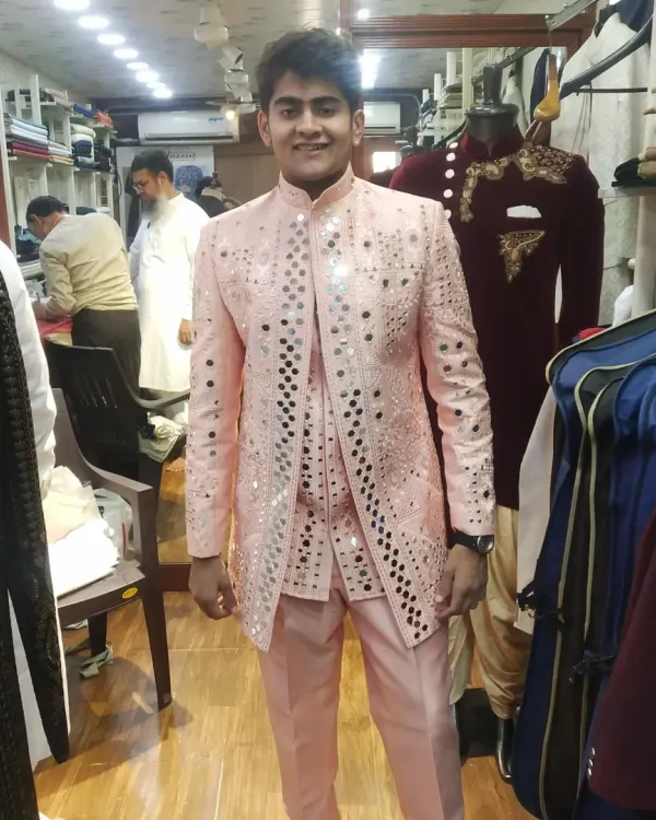 A happy client is our best advertisement. This custom-made pink Indo-Western jacket, featuring intricate mirror work, was designed for a celebration and tailored for a perfect fit. We can create a similar statement piece for your next big event.