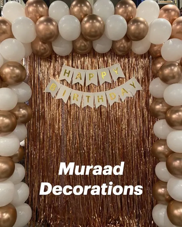 A simple yet classic balloon frame against a rose gold fringe curtain. The white and chrome copper balloons create an elegant photo booth for any celebration.