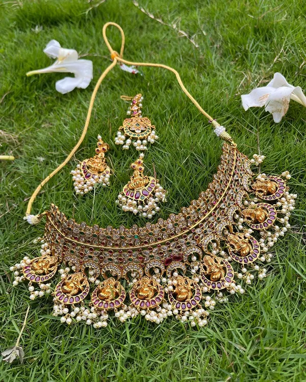 A beautiful antique-finish choker with Lakshmi motifs and pearl drops. This piece can be rented on its own or paired with a longer necklace.