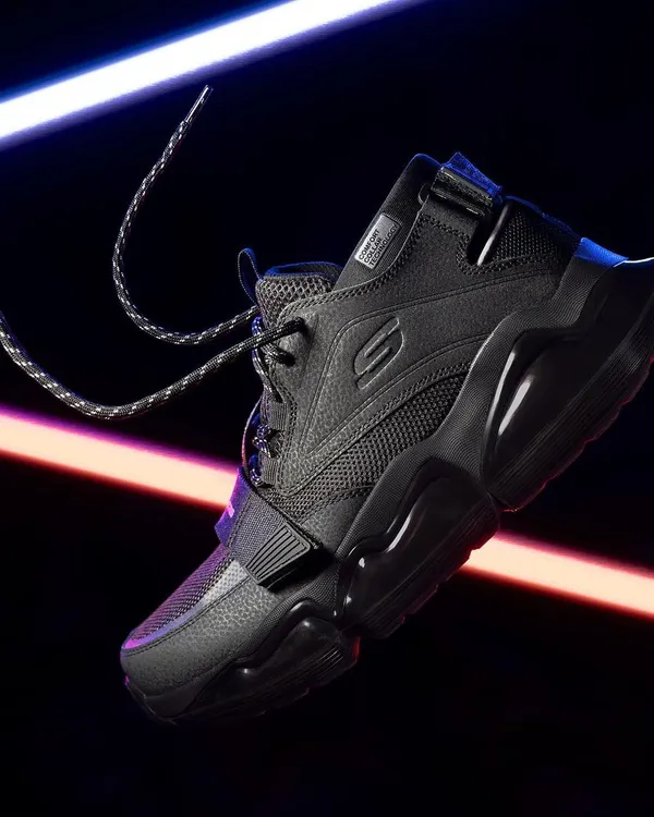 A dynamic, floating shot of Skechers shoes with creative light trails. This energetic style is perfect for performance footwear and captures a sense of movement and technology.
