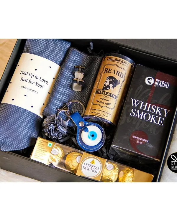 Our 'Styled with Love' hamper is the perfect gift for him. It includes a stylish tie and cufflinks, Beardo beard oil, Whisky Smoke perfume, and an evil eye keychain for good vibes.