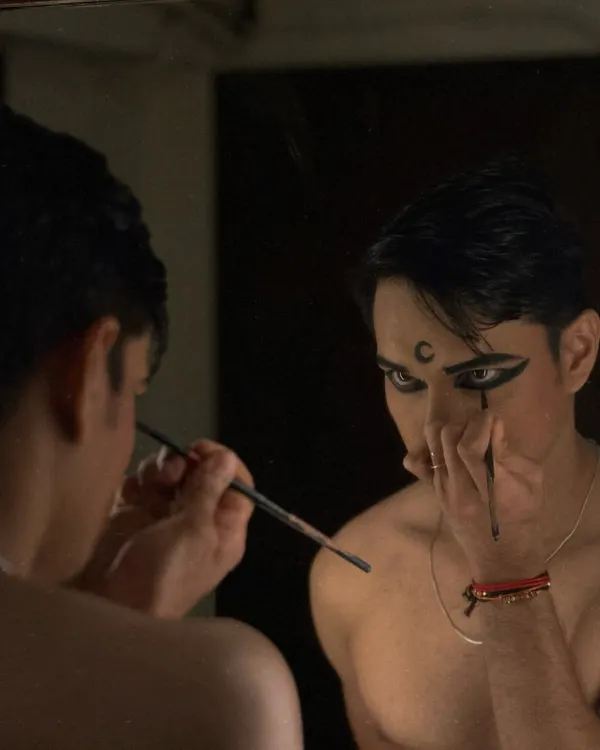 The process of getting ready is a ritual in itself. Here, I'm applying the final touches to the eye makeup, a key part of the Bharatanatyam look.