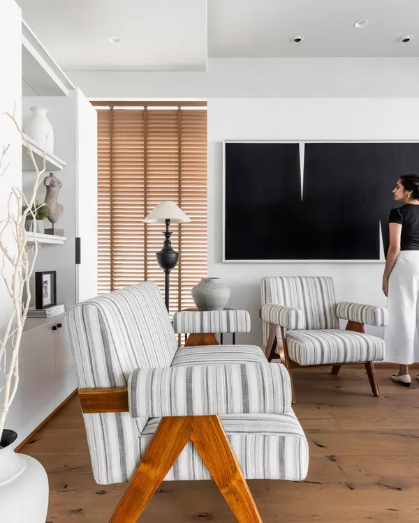 The Director's Cabin is a blend of contemporary luxury and calming sophistication. Here, I am seen contemplating the space, which features high-end materials, neutral tones, and a custom-made artwork to create an environment that is both inspiring and professional.