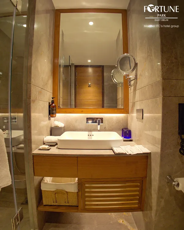 Our bathrooms are designed for function and comfort. They feature a clean, modern vanity with a large mirror, excellent lighting, and a magnifying mirror for your convenience.