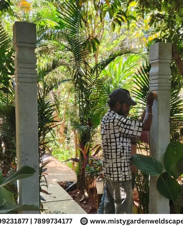 Our team carefully installing heavy, natural stone pillars for an archway at a farmhouse. This traditional feature adds a sense of timeless elegance to the landscape.