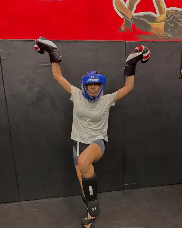 You are a warrior, a fighter, a force of nature. This is one of our female fighters, fully geared up and celebrating her strength. We train women to be fierce and unstoppable.