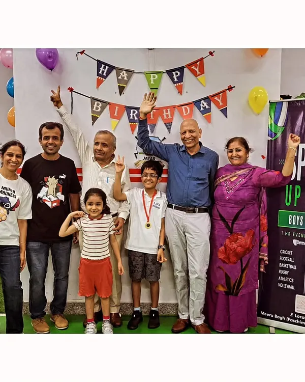 A picture perfect birthday moment with the whole family. The birthday boy, medal and all, celebrating his special day with his biggest supporters. We love having parents and grandparents join in the celebration.