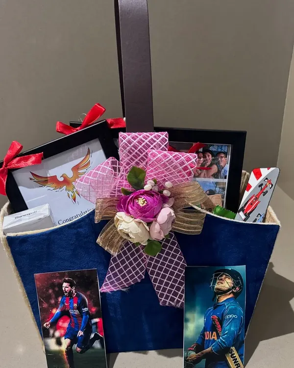 A graduation hamper for a sports fan. This gift celebrates a huge milestone with personalized touches like Messi and Dhoni photos, custom frames, and a mini canvas painting.