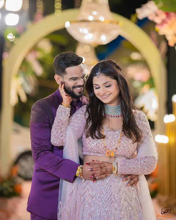 A candid, happy moment from Abhilash and Jagruti's engagement. I focus on capturing genuine smiles and interactions against the beautifully decorated backdrop of your event.