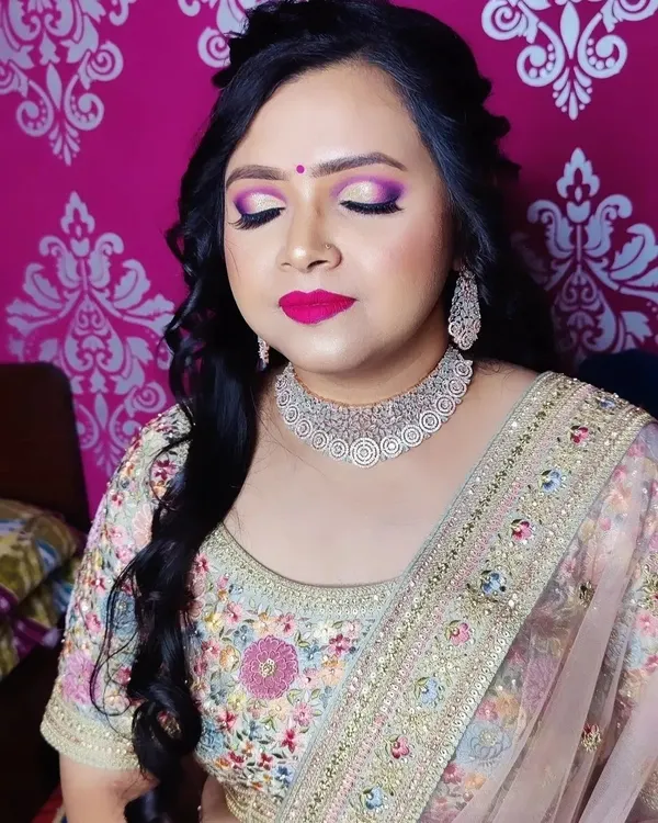A perfect engagement look featuring dramatic purple and pink eyeshadow, a bold magenta lip, and a beautiful diamond choker. The half-up, half-down hairstyle with soft curls completes this glamorous look.