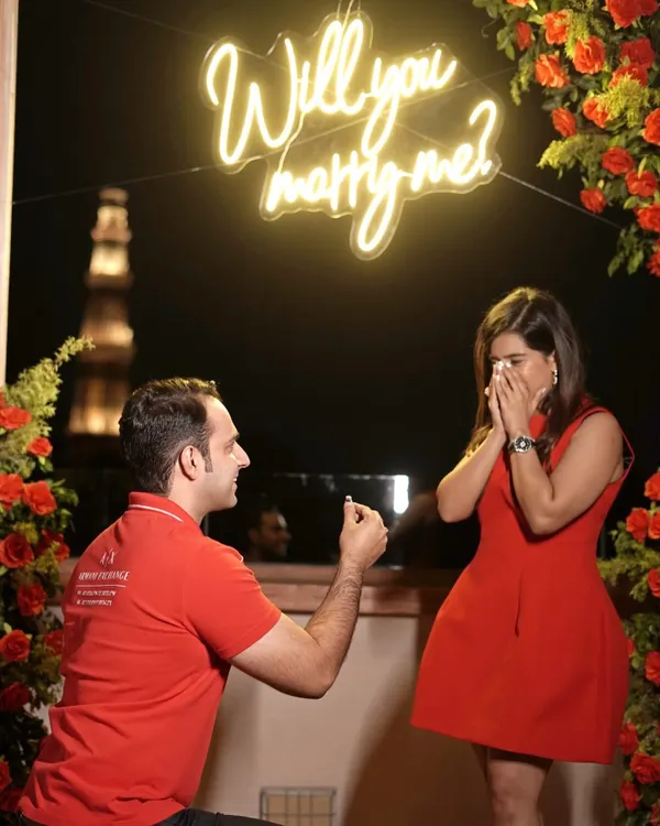 A perfect moment captured, where love says 'yes' against the timeless silhouette of the Qutub Minar. I help you craft proposals that are as unique and beautiful as your own love story.