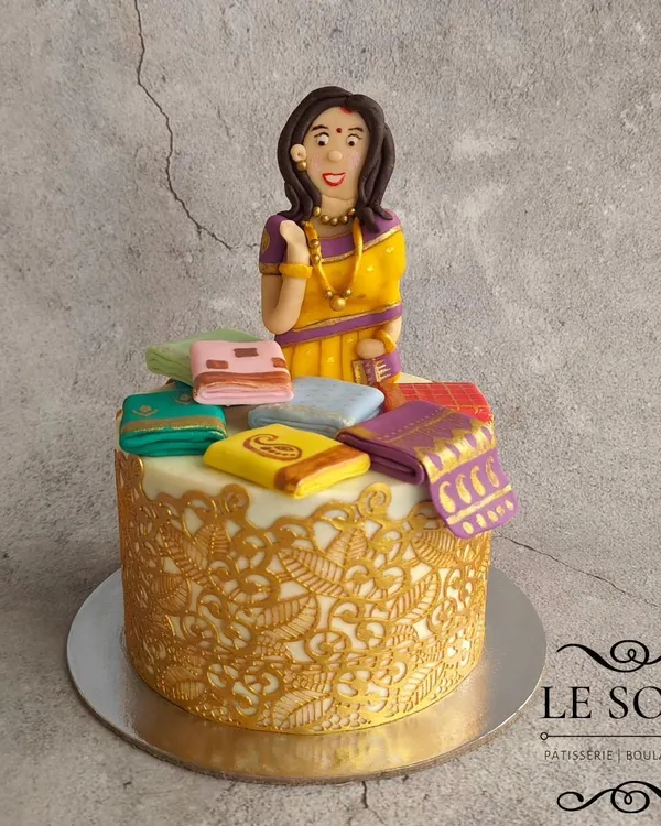 This saree-themed cake is one of my signature designs and never goes out of style. This half-kg Red Velvet cake features a beautiful figurine surrounded by a stash of tiny, hand-painted fondant sarees.