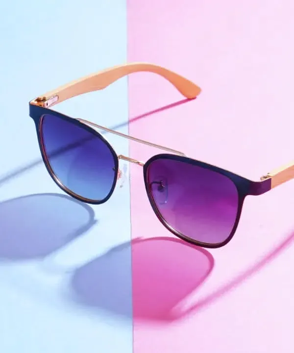 This shot for a sunglasses brand uses a dual-tone background and colored gels on the lights to create these vibrant, contrasting shadows. It's a great example of how creative lighting can make a product pop for an ad campaign.