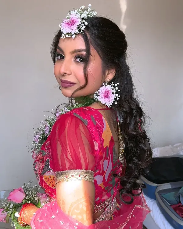 My bride Swati, looking fresh and beautiful for her "Phoolon ki Haldi" or flower shower event. We kept the makeup very natural and created a fun, glamorous hairstyle to match the happy vibe.