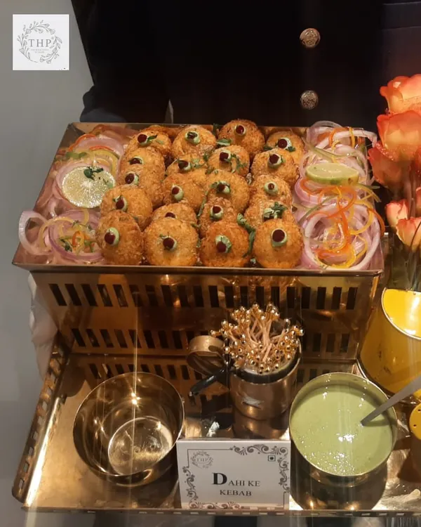 Our Dahi Ke Kebabs are a must-try. Crispy on the outside and soft on the inside, they are served on a beautiful golden tray with fresh mint chutney, making for a perfect vegetarian starter.