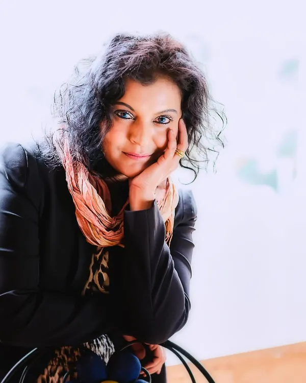 A bright, high-key color portrait where the subject connects directly with the camera. Her expressive eyes and gentle pose invite you into her world, showcasing the open and healing nature of the photo session.