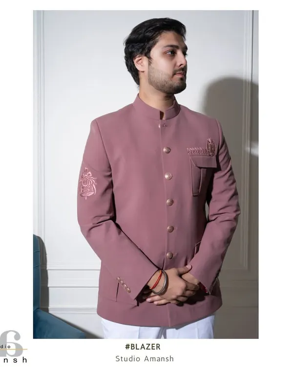 Our pastel pink Prince Coat, tailored in a classic Jodhpuri style. This front-facing view shows the clean button line and the subtle Resham embroidery on the pocket flap and sleeve.