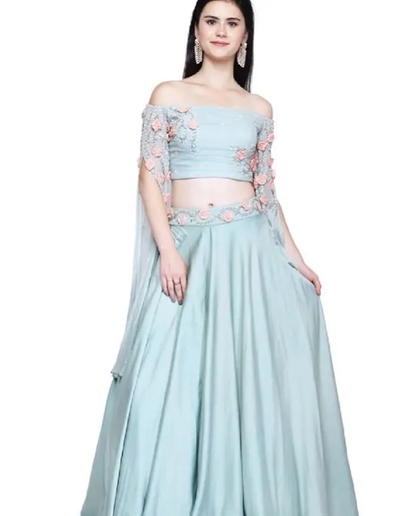 This stunning light blue off-shoulder lehenga is a perfect example of the modern, high-fashion pieces available in our outlet. The delicate 3D floral embroidery on the blouse and waist adds a touch of romance, making it ideal for a sangeet or a friend's wedding.