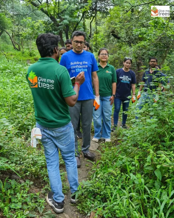Our team guiding volunteers from Marsh India through a dense, forested area. We always start with a nature walk to help volunteers connect with the environment they are about to nurture.