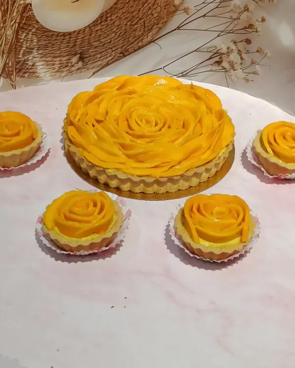My mango tarts are a seasonal highlight, available in both a large, shareable size and as lovely individual mini tarts. Each one is a beautiful arrangement of fresh mango over a rich, creamy filling.