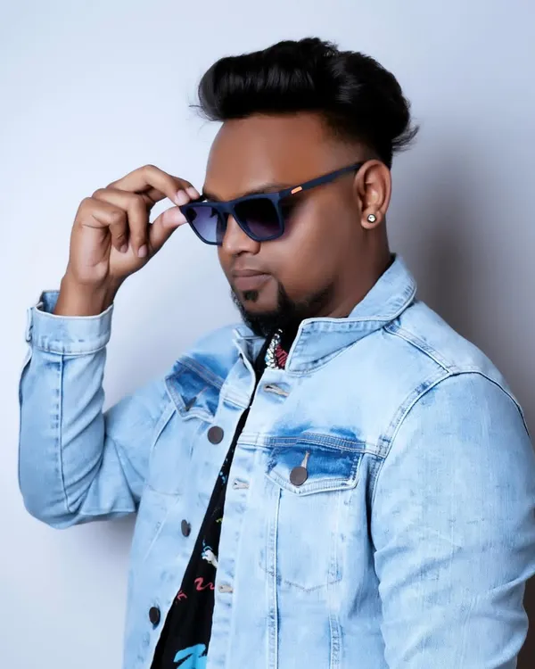 A clean studio shot reflecting my cool and confident style. The denim jacket and shades are part of my signature look.
