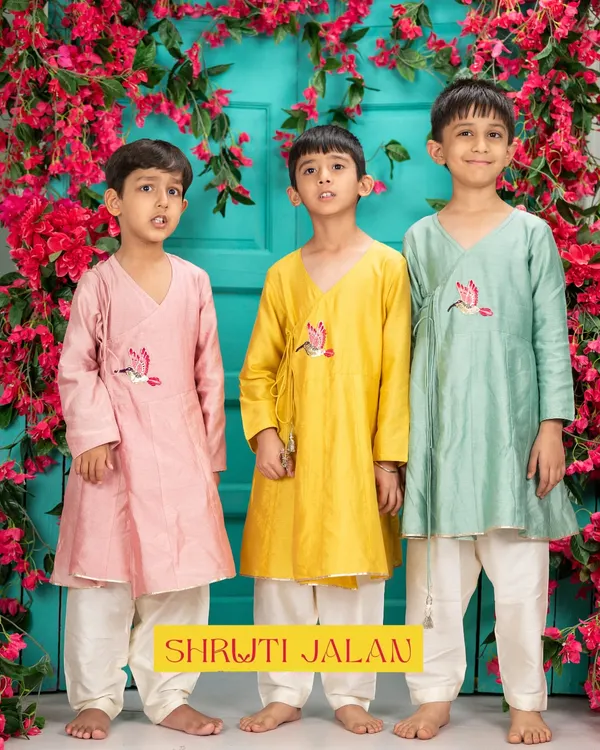 Three brothers, three times the charm. This image showcases my Angrakha-style kurtas in beautiful pastel shades of pink, yellow, and green. The delicate bird embroidery adds a unique touch to this traditional silhouette.