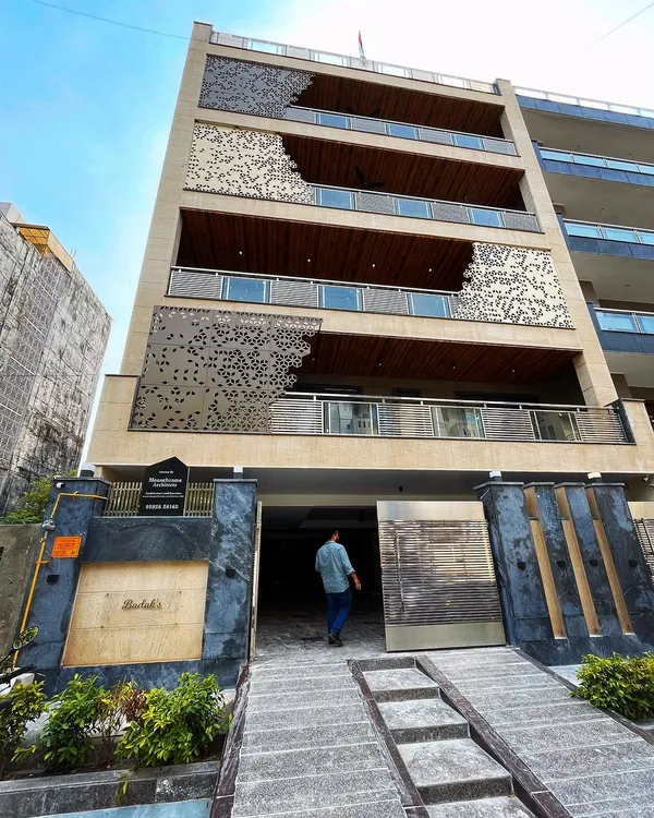Here is a look at one of our completed residential projects in Gurgaon. I focused on creating a strong visual identity for the building by layering different materials like limestone, wood cladding, and a custom CNC-cut metal jali. The goal was to design a facade that is modern, sophisticated, and has a powerful street presence.